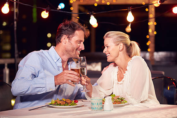 Mid-40s couple on a date enjoying dinner together